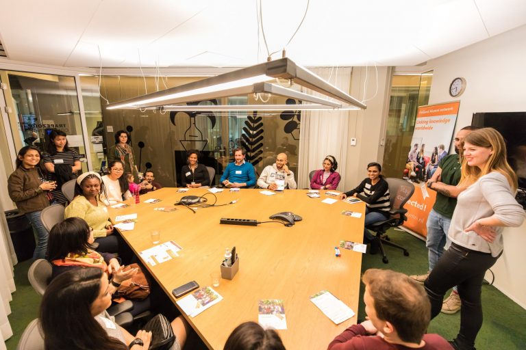 Group around a table interacting with speaker